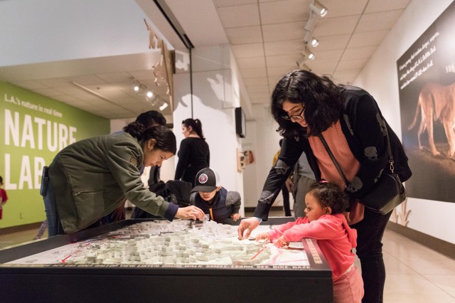 Mother and daughter looking at topographic map in P-22 exhibition