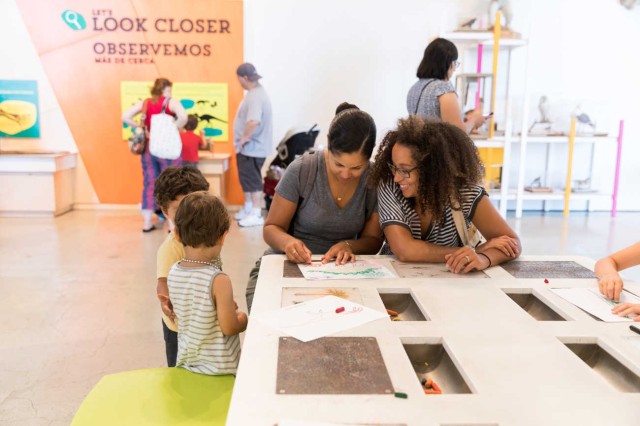 Visitors drawing in the Paleo Play Zone in the Discovery Center