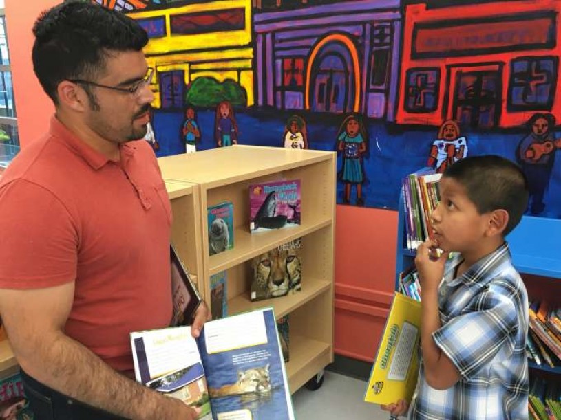 Kevin and Miguel having a discussion about pumas after they go through a puma natural history book together.