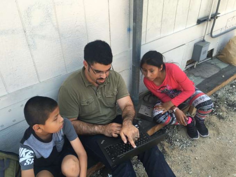 Miguel reviewing camera trap photos with the students