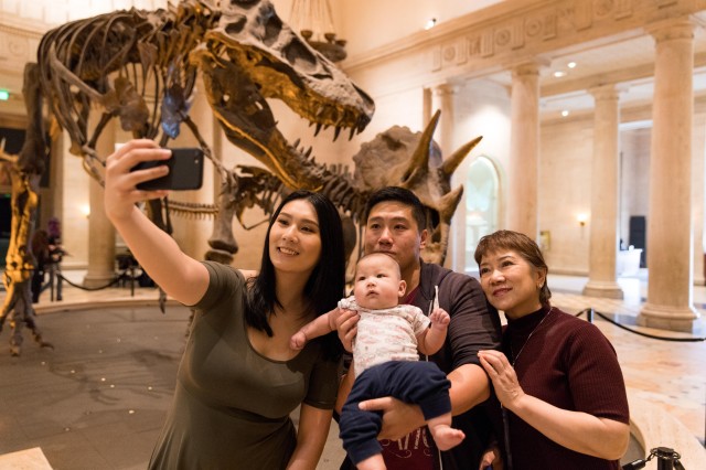 Family takes selfie in front of Dueling Dinos